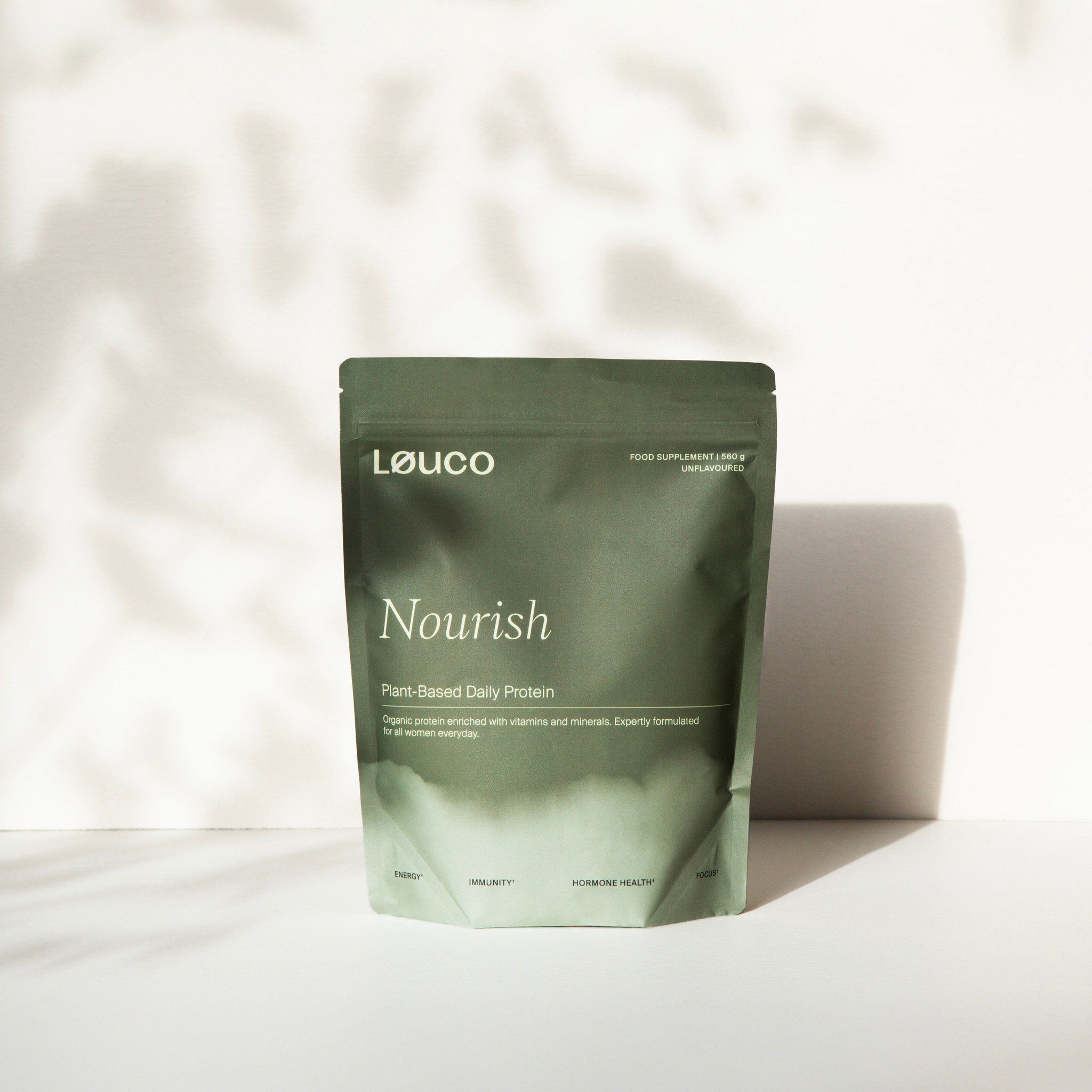 Green Løuco protein powder package on a light background