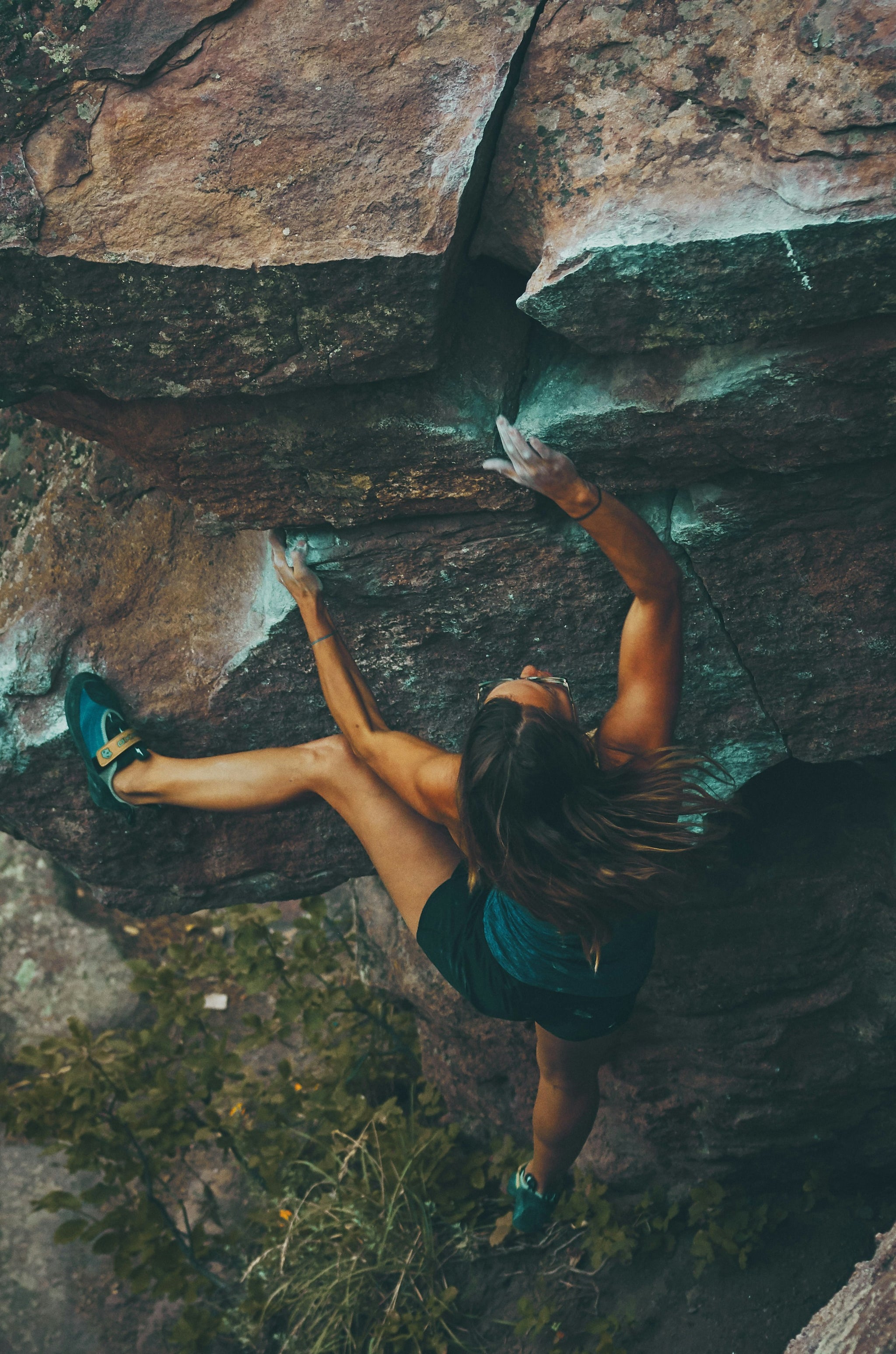 Empowered woman rock climbing 